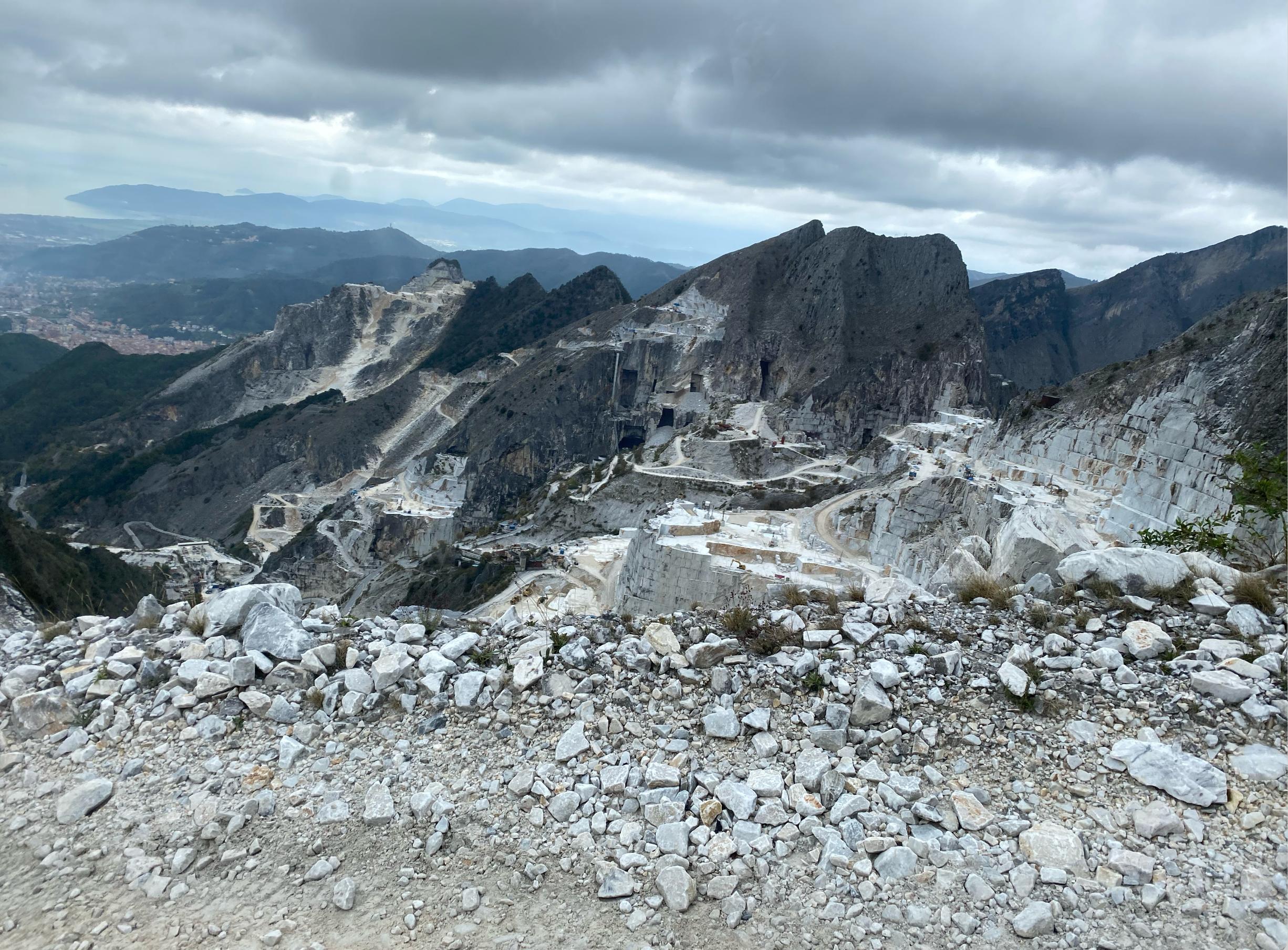 Dramatic European stone quarry beneath a mountainous sky