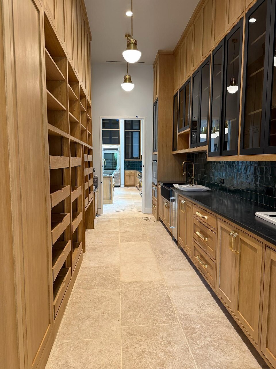 French limestone flooring installed through a custom wood pantry