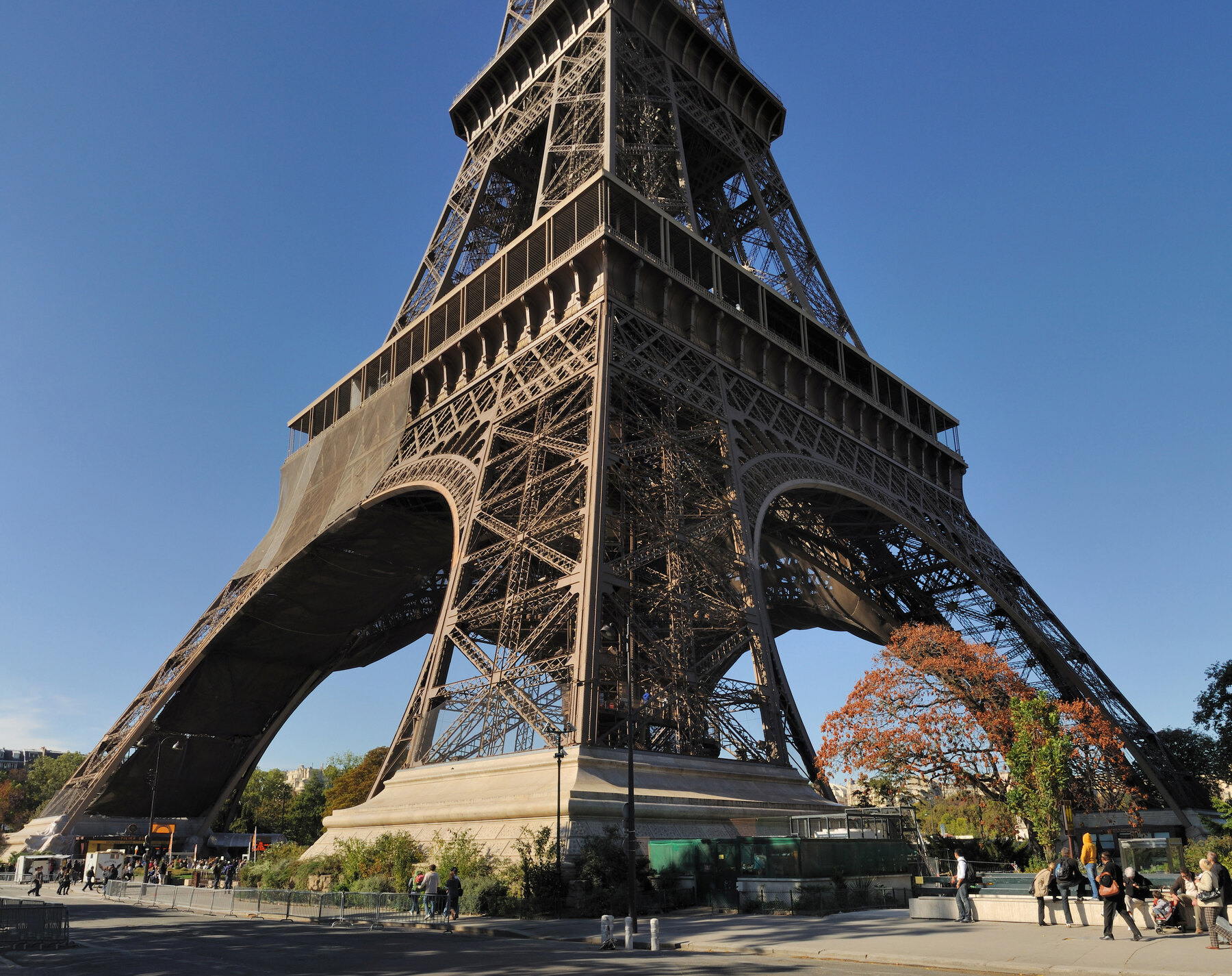 Base of the Eiffel Tower showing stone foundation beneath the iron structure